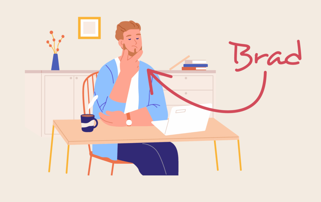 Person with the name Brad sitting at desk with chin in hands